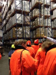 Kids wear warm coats and hats on a JerseySTEM trip to Preferred Freezer Warehouses